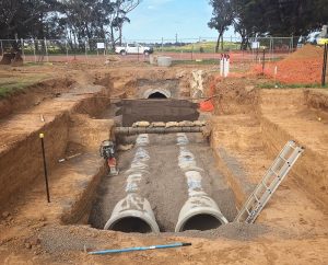 Installing stormwater pipes underneath an 8 inch oil pipeline